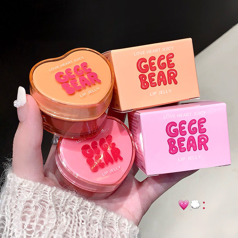 GEGE BEAR lip jelly with packaging held by a hand on a neutral background