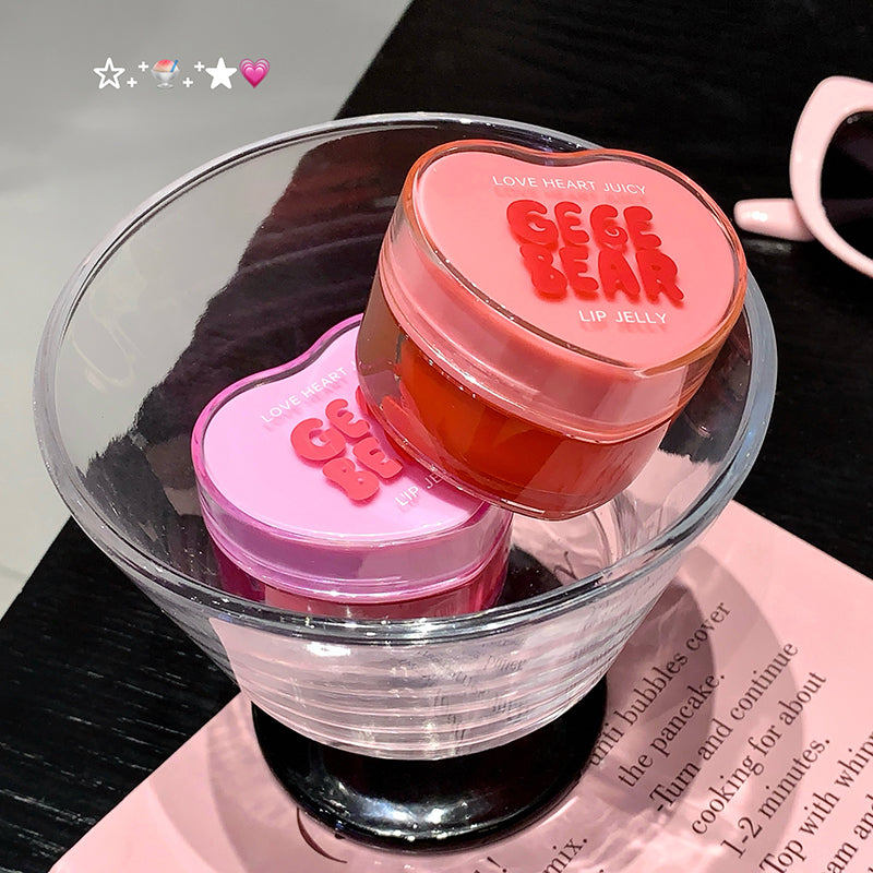 Two heart-shaped lip jelly containers with 'Gee Ge Bear' branding on a glass dish.