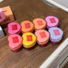 Heart-shaped containers with 'CECE BEAR' text on a wooden surface