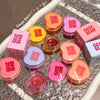 Collection of GECE BEAR lip balm containers on a reflective surface.