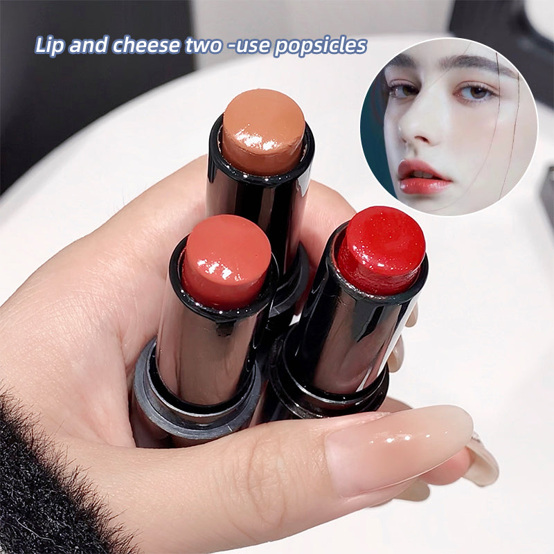Hand holding three lipsticks with close-up inset of a person wearing red lipstick.
