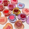 Collection of Gege Bear lip jelly jars in various colors on a white background