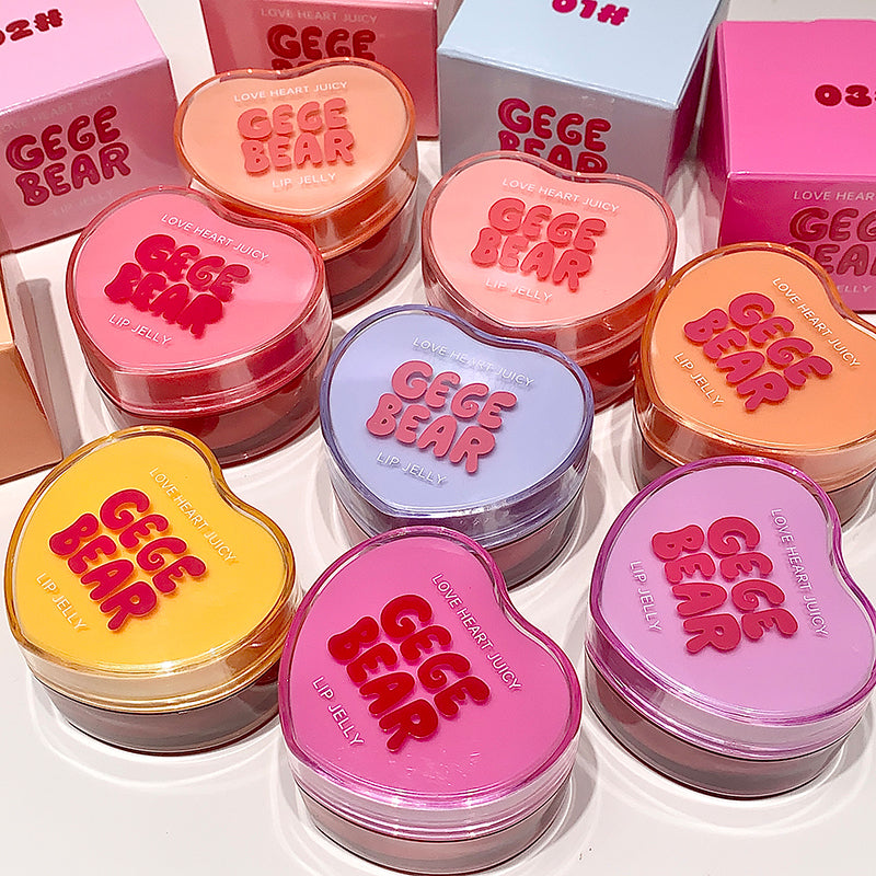 Collection of GEGE BEAR lip balms in various colors with boxes in the background.