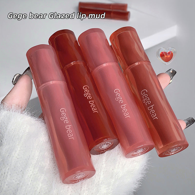 Four Gege bear Glazed lip mud products on a white surface with a blurred background.