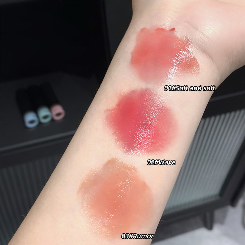 Three different shades of lipstick swatched on a person's arm with labels.