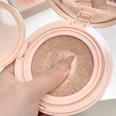 Compact powder with a hand holding it open, showing the texture.