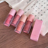 Set of pink lip products with 'Geobe' branding on a wooden surface.