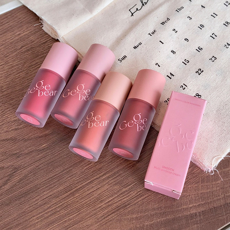 Set of pink lip products with 'Geobe' branding on a wooden surface.