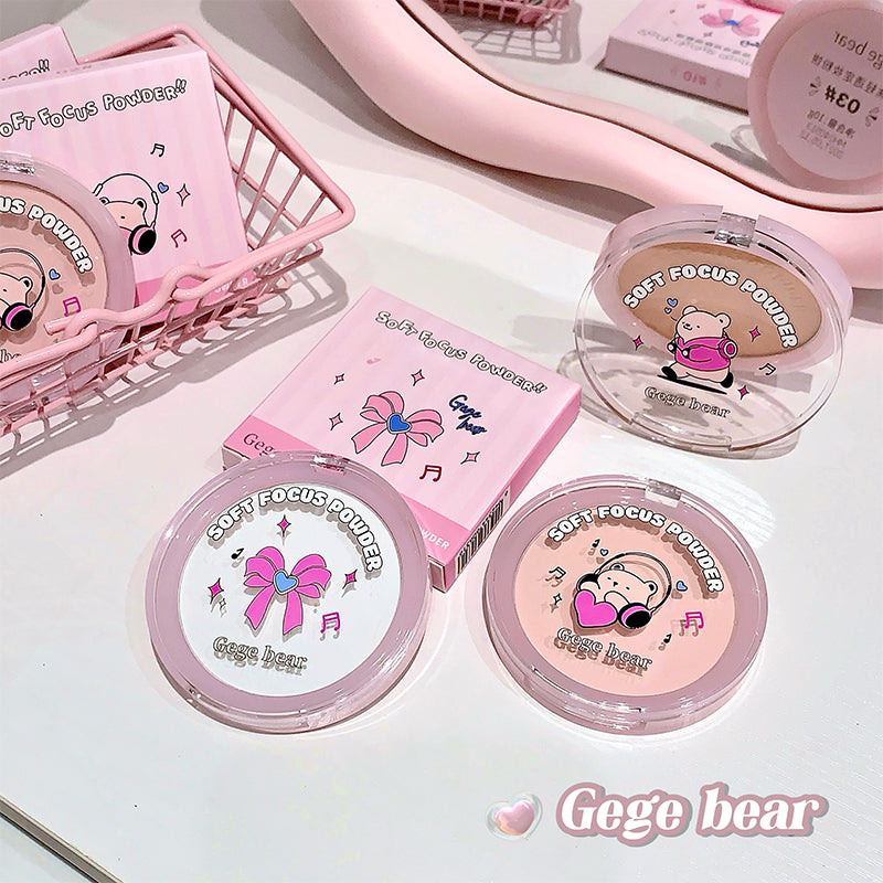 Pink makeup products with cartoon character design on a white surface, featuring the brand 'Gege bear'.