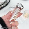 Hand holding a small perfume bottle with measurements and product name.