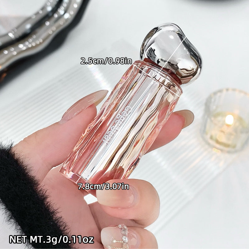 Hand holding a small perfume bottle with measurements and product name.