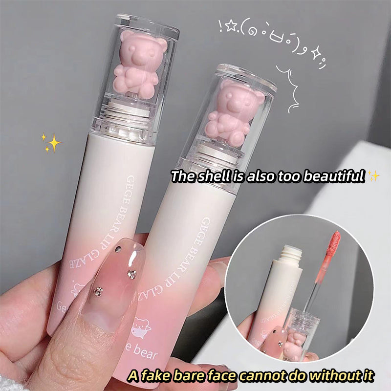 Two lip glosses with bear-shaped caps held by a hand, with text praising the product.
