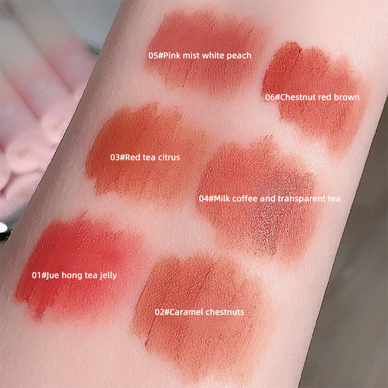 Lipstick swatches on a person's arm with color names and codes.