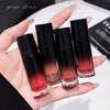 Hand holding four GEGE BEAR lip glosses with gradient colors on a white background