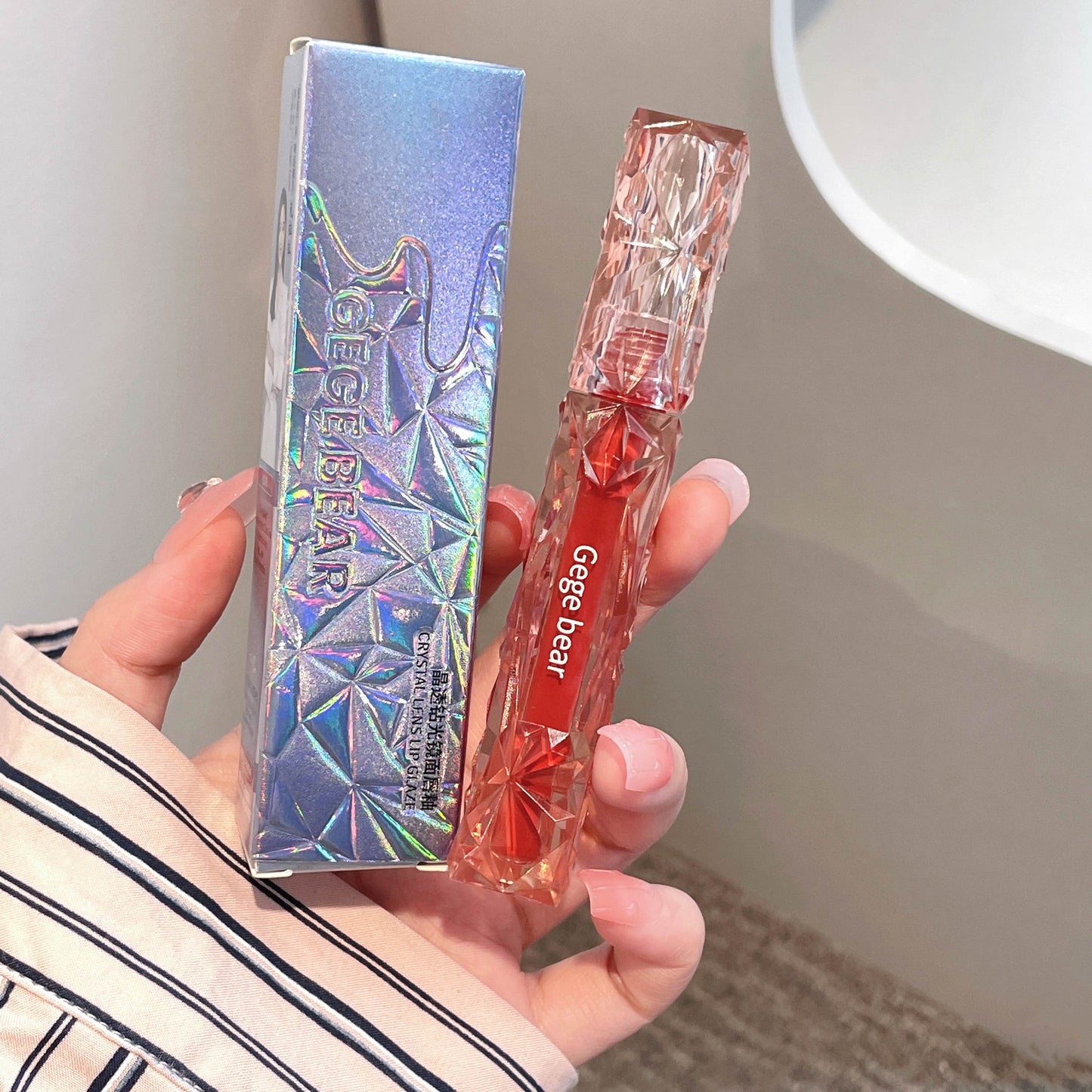 Hand holding a transparent pen with red accents and 'Geege bear' branding.