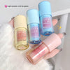 Four light powder mist lip glazes held by a hand on a white background