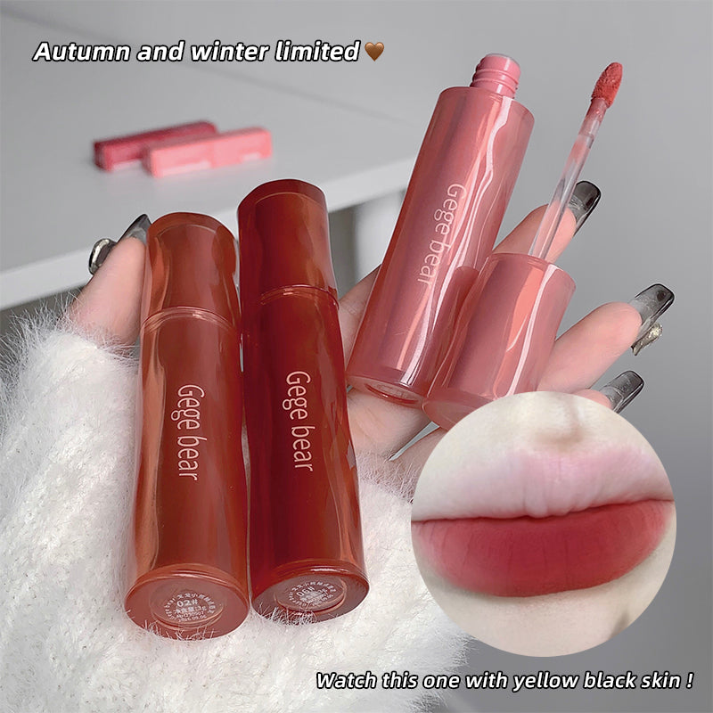 Lip gloss products with 'Gege bear' branding on a textured surface.