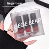 Set of three lipsticks in a Gege Bear packaging held by a hand.