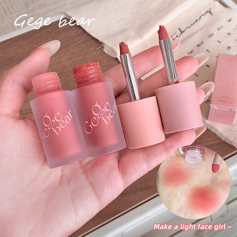 Hand holding pink lip products with 'Gege bear' branding on a wooden surface.