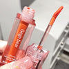 Lip gloss with applicator held by a hand, brand 'Gege bear' visible