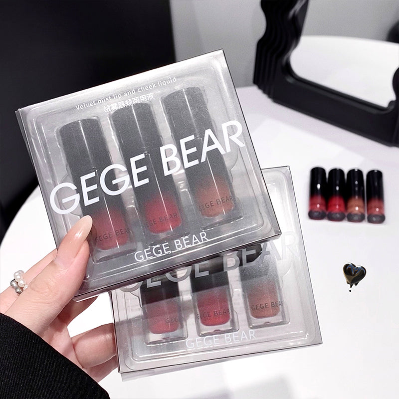 Set of GEGE BEAR lipsticks in clear packaging held by a hand.