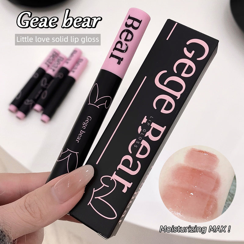 Gege bear Little love solid lip gloss with packaging and a hand holding it.