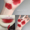 Hand with red lipstick swatches and a close-up of lips with the same shade.