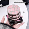 Stack of GECE BEAR makeup products held by a hand on a light background