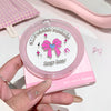Pink compact powder with 'Geege bear' branding held by a hand.