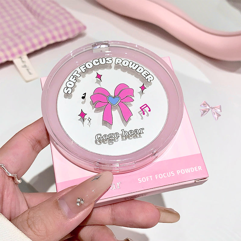 Pink compact powder with 'Geege bear' branding held by a hand.