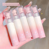 Set of five gradient lip balms with bear-shaped caps held in a hand.