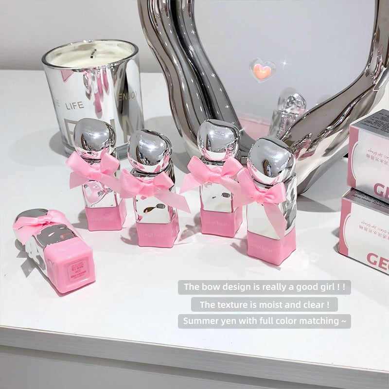 Silver and pink decorative items on a white surface with text overlay.
