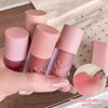 Set of pink lip glosses with visible brand name, held by a hand.