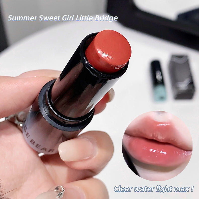 Lipstick held by a hand with an inset of lips wearing the lipstick color.