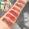 Lip gloss swatches on a person's arm with product names and a small inset of two cartoon bears.