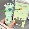 Lip gloss with a bear design and its packaging held by a hand.