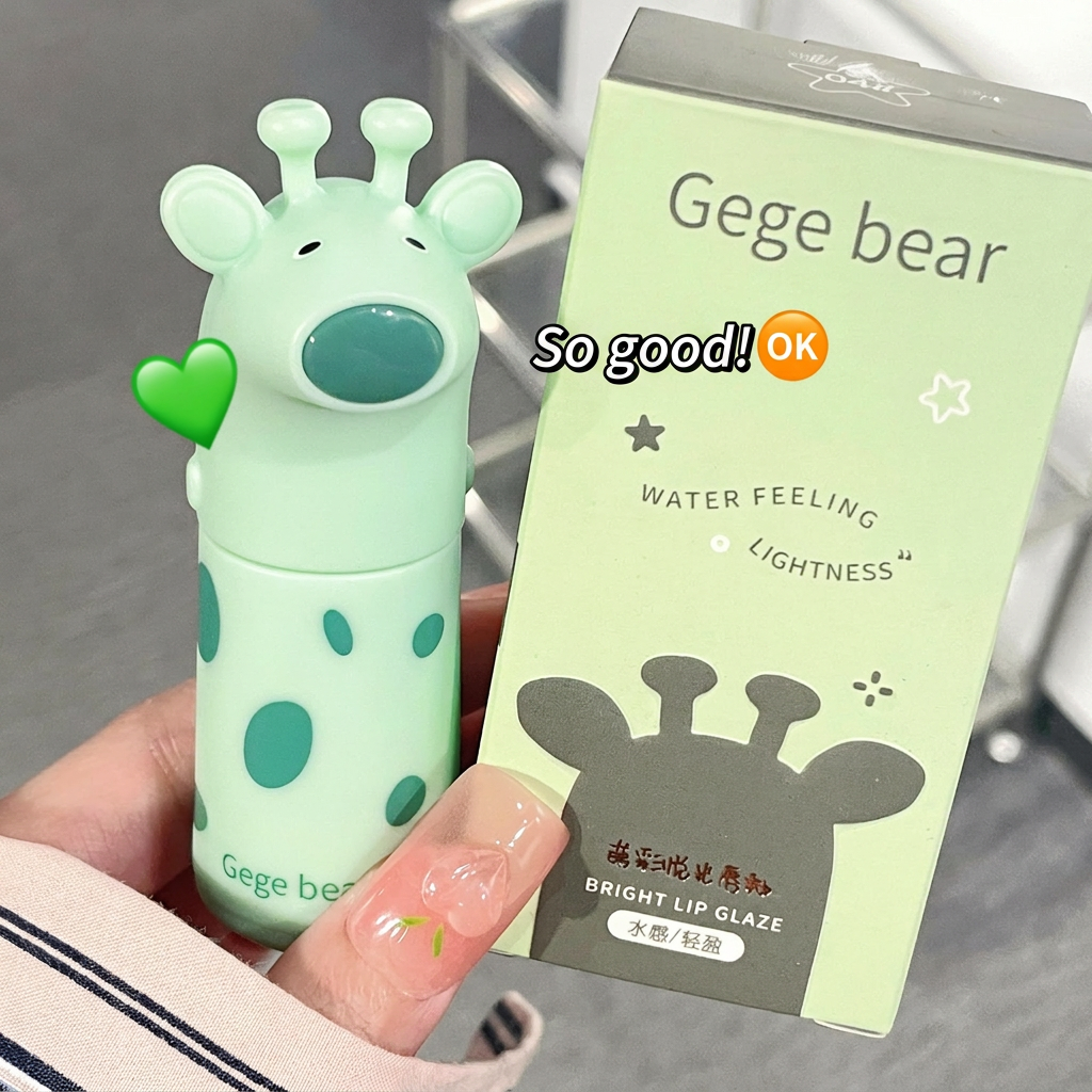 Lip gloss with a bear design and its packaging held by a hand.