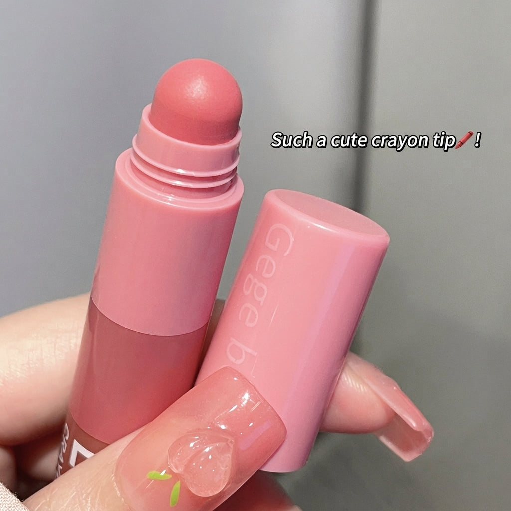 Pink lip balm with a cute crayon tip held by a hand against a gray background