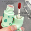 Green lip gloss with a red applicator and text describing its features.
