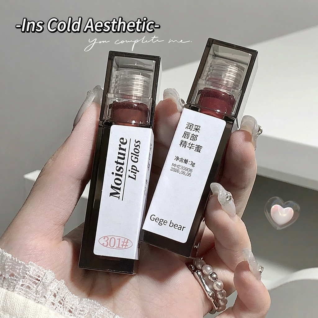 Two lip glosses held in a hand with a blurred background