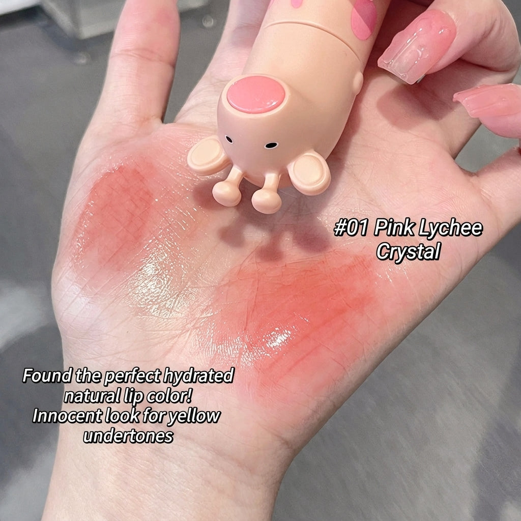 Hand with pink lip balm labeled '#01 Pink Lychee Crystal' on a neutral background