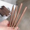 Four Gege bear liquid pens held by a hand on a light wooden surface.