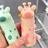 Two cartoonish lip balms, one pink with polka dots and one green with spots, held by a hand.