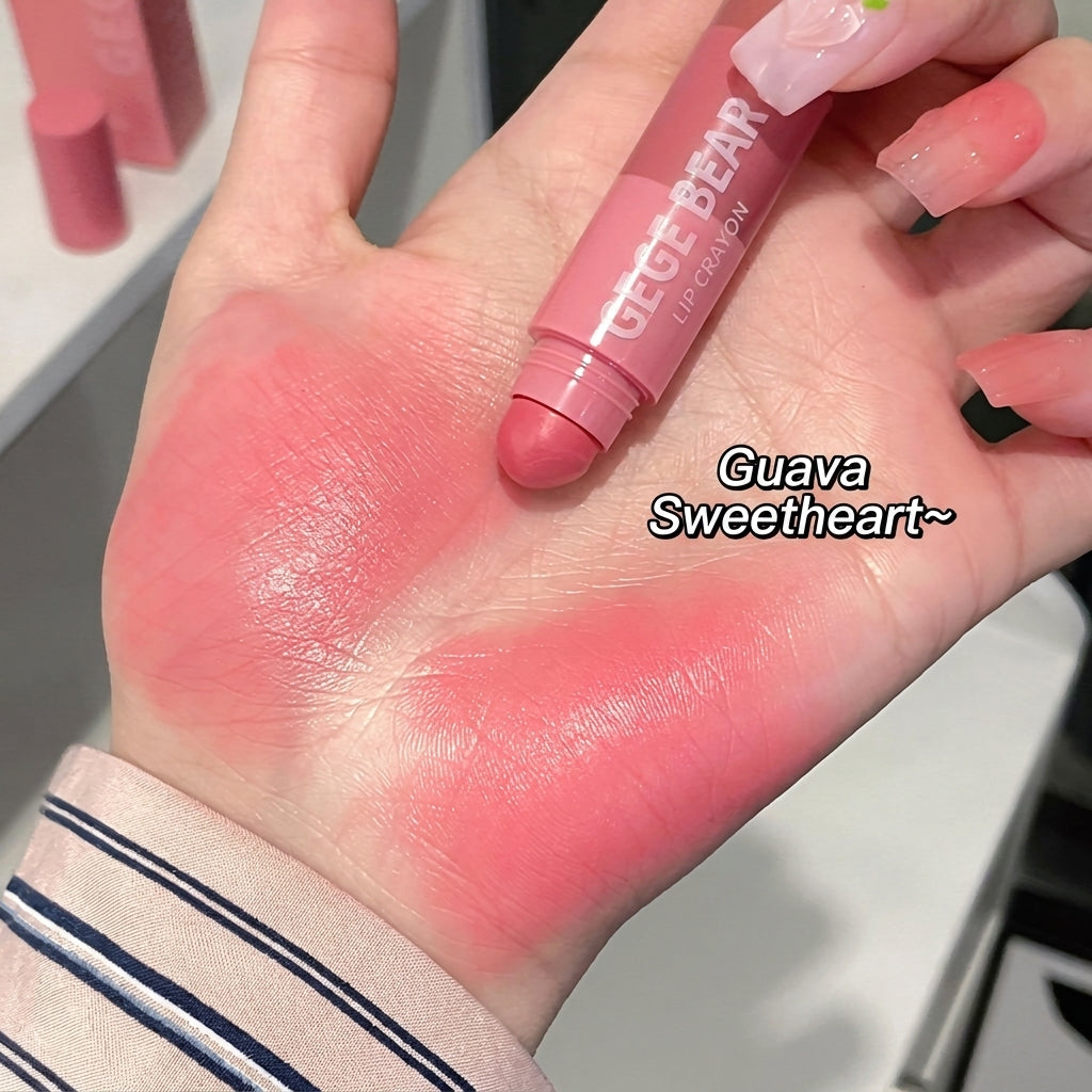 Hand with pink lip balm and swatches on skin, labeled 'Guava Sweetheart'.