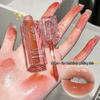 Lip balm with a hand holding it, showing color swatches on the palm.