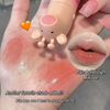 Lip balm with a small robot design on a hand, showing a swatch of color.
